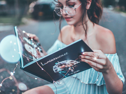 A woman reading a photography book