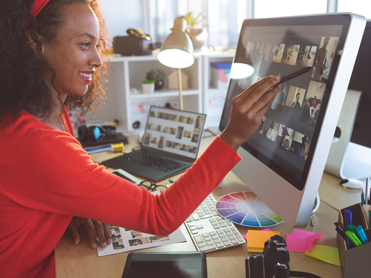 A woman editing a photo on a monitor