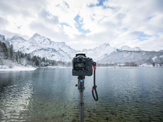 A camera on a yripod taking a landscape photogra