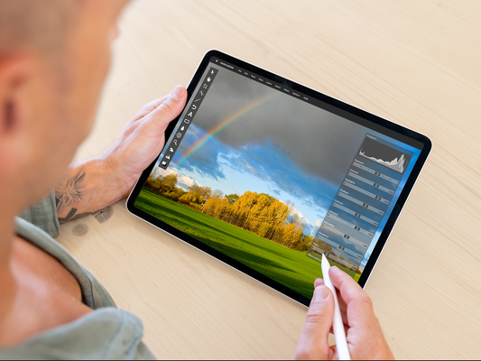 A man using a tablet for photo editing